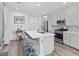 Well-lit kitchen with stainless steel appliances, island with seating, and modern pendant lights above at 108 Kimberlite Dr, Henderson, NV 89011