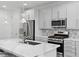 Bright kitchen featuring stainless steel appliances, white cabinets, and a center island with quartz countertop at 108 Kimberlite Dr, Henderson, NV 89011