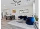 Living area featuring dining table, blue sofa and armchair, neutral walls, and grey wood-look floors at 108 Kimberlite Dr, Henderson, NV 89011