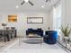 Living area featuring dining table, blue sofa and armchair, neutral walls, and grey wood-look floors at 108 Kimberlite Dr, Henderson, NV 89011