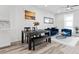 Comfortable living room with stylish decor, grey wood floors and bright white walls at 108 Kimberlite Dr, Henderson, NV 89011