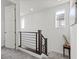 Modern staircase with gray carpet, wood railing, and bright white walls at 108 Kimberlite Dr, Henderson, NV 89011