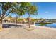 Beautiful waterfront view with mature trees lining a brick pathway leading to a charming community at 108 Kimberlite Dr, Henderson, NV 89011