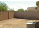 Backyard enclosed by a block fence and desert landscaping at 108 Zenith Point Ave, North Las Vegas, NV 89032