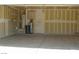 Garage featuring a water heater, shelves, and a plain white door at 108 Zenith Point Ave, North Las Vegas, NV 89032