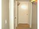 Hallway featuring neutral walls, carpet, and a door with brass fixtures at 108 Zenith Point Ave, North Las Vegas, NV 89032