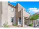 Contemporary two-story home with light-colored stone exterior and balcony at 11713 Redwood Mountain Ave, Las Vegas, NV 89138