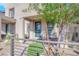 Modern home with teal front door and landscaped entryway at 11713 Redwood Mountain Ave, Las Vegas, NV 89138