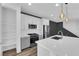 Modern kitchen with white cabinets, stainless steel appliances, and pantry at 11713 Redwood Mountain Ave, Las Vegas, NV 89138