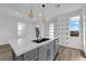 Kitchen island with white quartz countertop and gray cabinets at 11713 Redwood Mountain Ave, Las Vegas, NV 89138