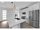 Modern kitchen island with white cabinets and stainless steel appliances at 11713 Redwood Mountain Ave, Las Vegas, NV 89138