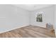 Bright bedroom with wood-look floors and a window view at 11908 Love Orchid Ln, Las Vegas, NV 89138