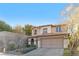 Charming two-story home showcasing a tile roof, desert landscaping, and a spacious two-car garage at 11908 Love Orchid Ln, Las Vegas, NV 89138