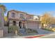 Beautiful two-story home featuring desert landscaping, a two-car garage, and a tile roof at 11908 Love Orchid Ln, Las Vegas, NV 89138