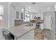 Bright kitchen featuring white cabinets, stone countertops, stainless steel appliances, and stylish backsplash at 11908 Love Orchid Ln, Las Vegas, NV 89138