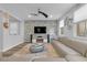 Bright living room with chic decor, gray stone accent wall, and large windows at 11908 Love Orchid Ln, Las Vegas, NV 89138