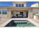 Exterior shot of a backyard featuring an outdoor seating area and a narrow in-ground pool at 12 Hilltop Crest St, Henderson, NV 89011