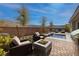 Backyard retreat with a waterfall pool, fire pit, grill, and lounge chairs at 12 Hilltop Crest St, Henderson, NV 89011