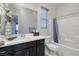 This bathroom features a single sink vanity and a shower-tub combo with gray accents at 12 Hilltop Crest St, Henderson, NV 89011