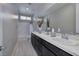 This bathroom is brightly lit and features a dual sink vanity and modern fixtures at 12 Hilltop Crest St, Henderson, NV 89011