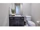 This half bath includes a sleek vanity with a sink and a modern toilet at 12 Hilltop Crest St, Henderson, NV 89011