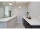 Stylish dry bar area with a white countertop, dark cabinetry, and modern pendant lighting at 12 Hilltop Crest St, Henderson, NV 89011