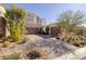 Beautiful two-story home featuring a well-manicured front yard and brick paved driveway at 12 Hilltop Crest St, Henderson, NV 89011