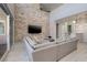 Elegant living room with a stone accent wall, sliding glass doors, and stylish furnishings at 12 Hilltop Crest St, Henderson, NV 89011