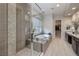 Modern bathroom with a glass shower, soaking tub, double vanity, and stylish tile details at 12 Hilltop Crest St, Henderson, NV 89011