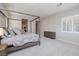 An airy main bedroom showcases a four-poster bed, dresser, plush carpet, and window with shutters at 12 Hilltop Crest St, Henderson, NV 89011