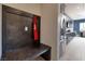 Mud room with custom built-in bench, coat hooks, and modern stainless steel refrigerator at 12 Hilltop Crest St, Henderson, NV 89011