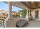 An elegant balcony with stone columns and wooden ceiling overlooks the scenic mountains at 1312 Enchanted River Dr, Henderson, NV 89012