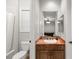 Bathroom with tiled walls, vanity sink and cabinets. Mirrored reflection shows game room at 1312 Enchanted River Dr, Henderson, NV 89012