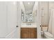 A charming bathroom with a wood vanity, white sink, and decorative anchor on the wall at 1312 Enchanted River Dr, Henderson, NV 89012