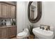 Stylish powder room featuring a vessel sink, decorative mirror and modern fixtures at 1312 Enchanted River Dr, Henderson, NV 89012