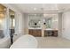 Elegant bathroom featuring stone countertops, dual sinks, vanity, and a free-standing tub with views at 1312 Enchanted River Dr, Henderson, NV 89012