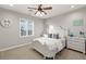 A bright bedroom features a white bed frame, matching dressers and beach-themed decorations at 1312 Enchanted River Dr, Henderson, NV 89012