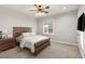 A bright bedroom features a modern wood bed frame, and neutral-toned walls at 1312 Enchanted River Dr, Henderson, NV 89012