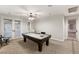 Game room with billiard table, ceiling fan and lighting with carpeted floors at 1312 Enchanted River Dr, Henderson, NV 89012