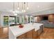 Bright and airy kitchen with an island sink overlooking an adjacent outdoor oasis and living space at 1312 Enchanted River Dr, Henderson, NV 89012