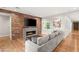 Bright living room with wood accent wall, fireplace, and hardwood floors at 1312 Enchanted River Dr, Henderson, NV 89012