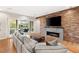 Living room with wood accent wall, fireplace and sliding glass doors to the outdoor patio at 1312 Enchanted River Dr, Henderson, NV 89012