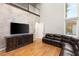 Bright living room with hardwood floors, grey brick accent wall and view from the second story at 1312 Enchanted River Dr, Henderson, NV 89012