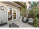 Outdoor patio area with seating and view into a room with bright decor through french doors at 1312 Enchanted River Dr, Henderson, NV 89012