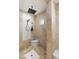 This shower is lined with stone tiles and features a rainfall shower head at 1312 Enchanted River Dr, Henderson, NV 89012