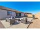 This backyard features a concrete patio with outdoor seating, a grill, and a grassy area at 136 Mosso Niente Pl, Henderson, NV 89011