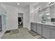 Bright bathroom includes dual vanities, a walk-in shower with glass doors, and access to a walk-in closet at 136 Mosso Niente Pl, Henderson, NV 89011