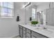 Bright bathroom with double sinks, quartz countertop, modern fixtures, and neutral color palette at 136 Mosso Niente Pl, Henderson, NV 89011