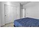 Bedroom with blue comforter on bed, closet, and bright lighting at 136 Mosso Niente Pl, Henderson, NV 89011