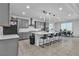 Modern kitchen with gray cabinets, stainless steel appliances, a large island, and an adjacent dining area at 136 Mosso Niente Pl, Henderson, NV 89011